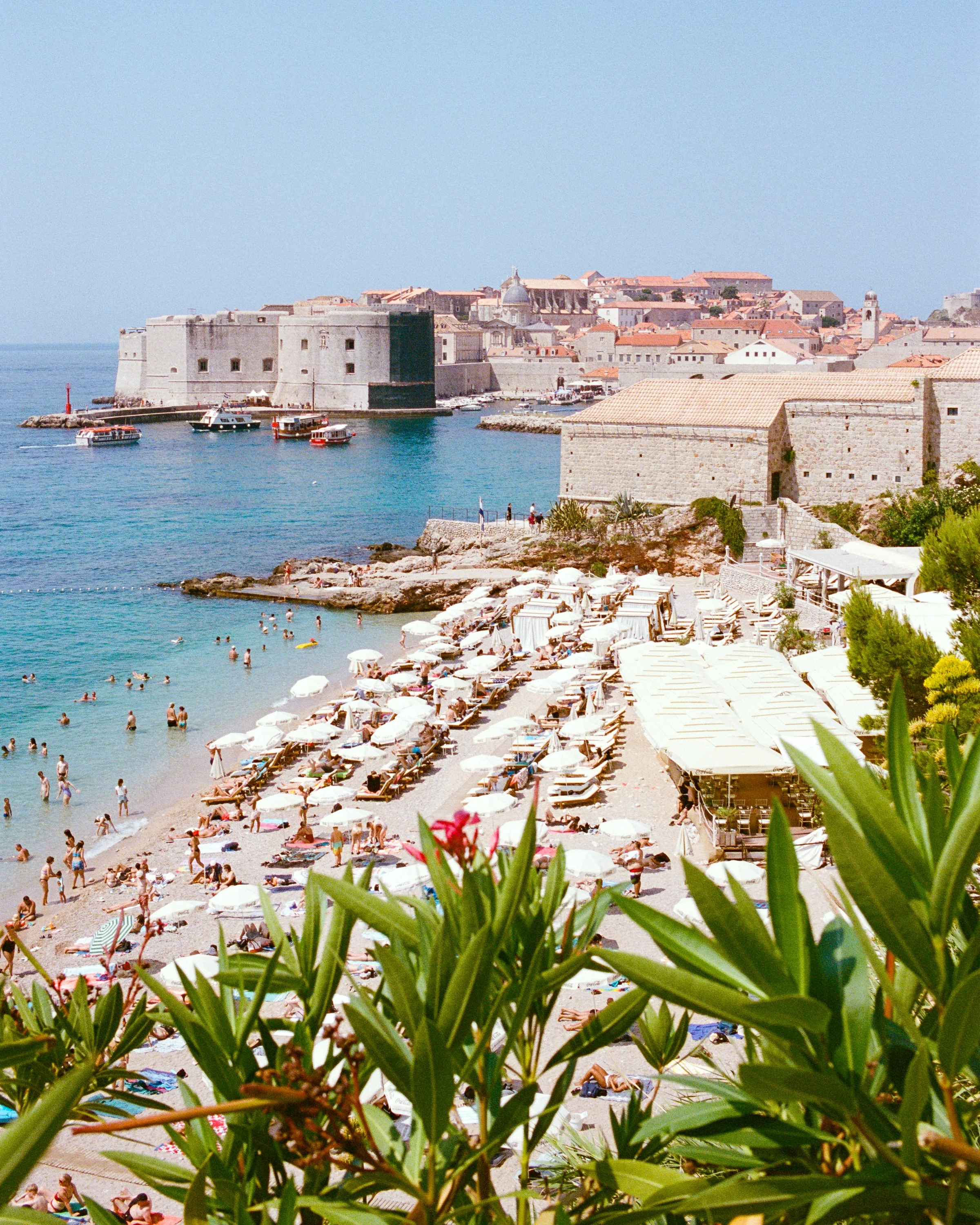 Banje beach crowded with sunbathers below Dubrovnik's old town