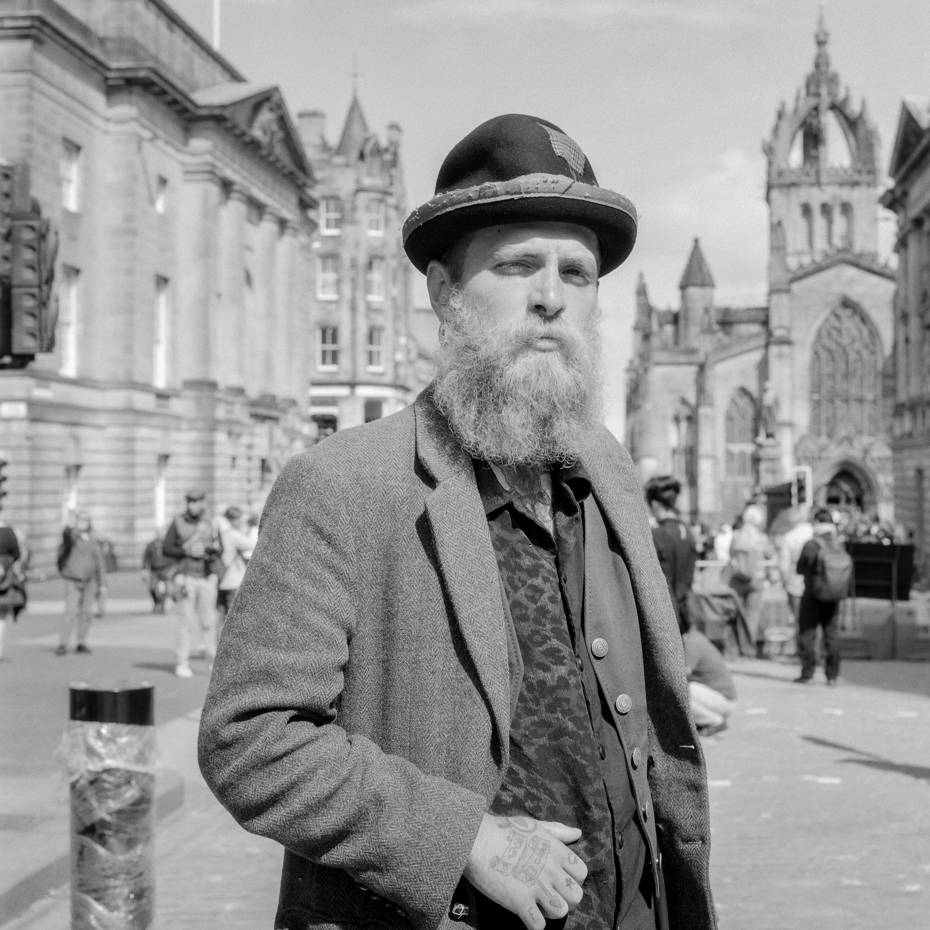 Black and white: a bearded man in a bowler hat on the Royal Mile