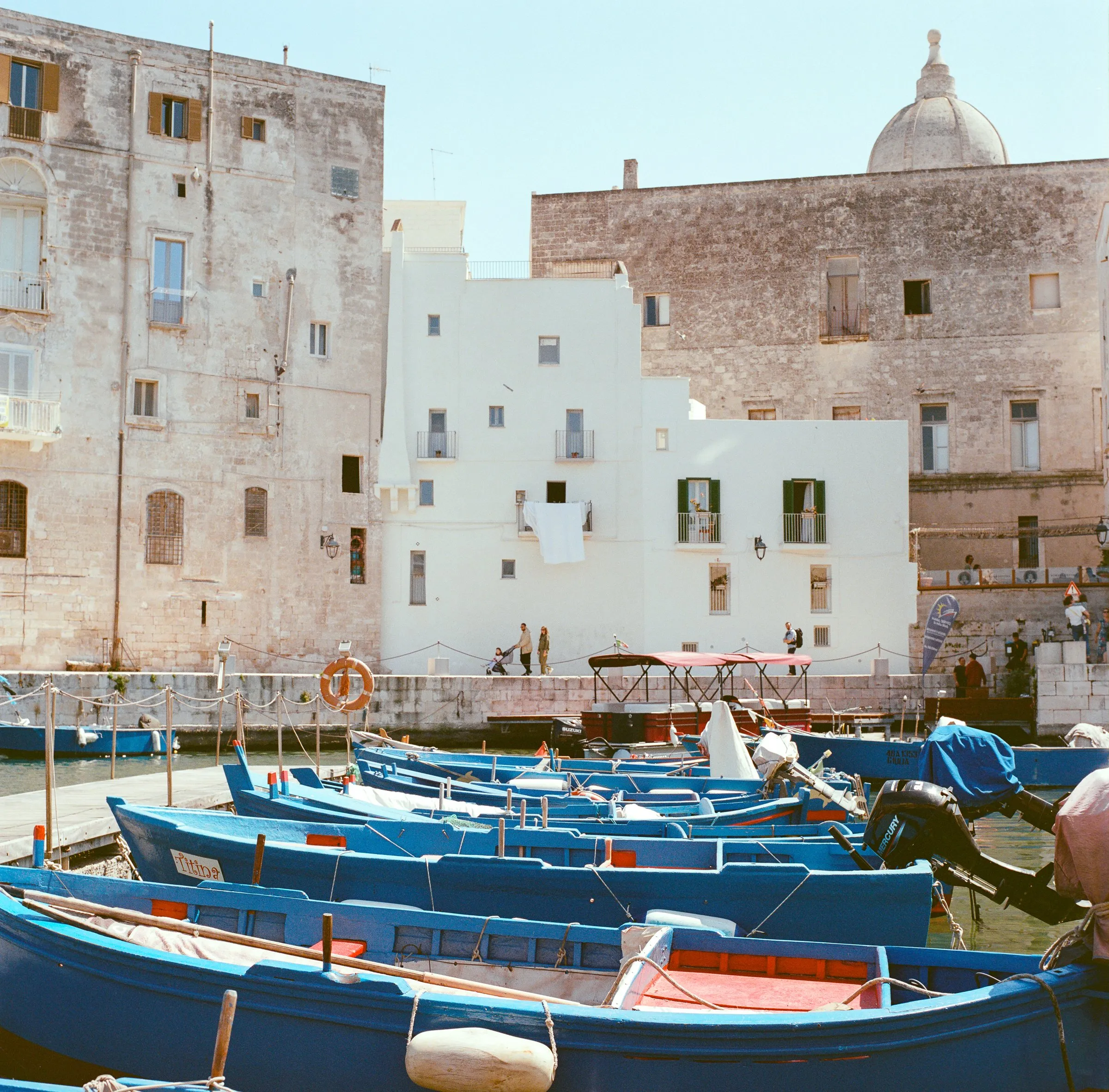 Blue fishing boats in Monopoli's old harbour