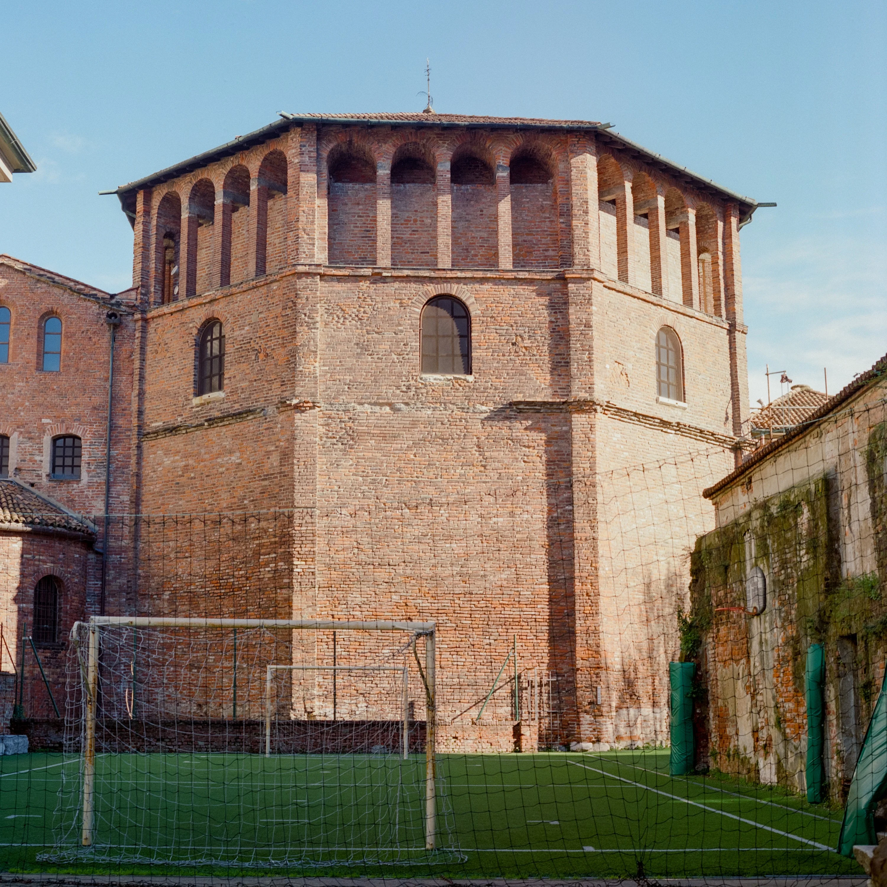 A brick tower above a football pitch