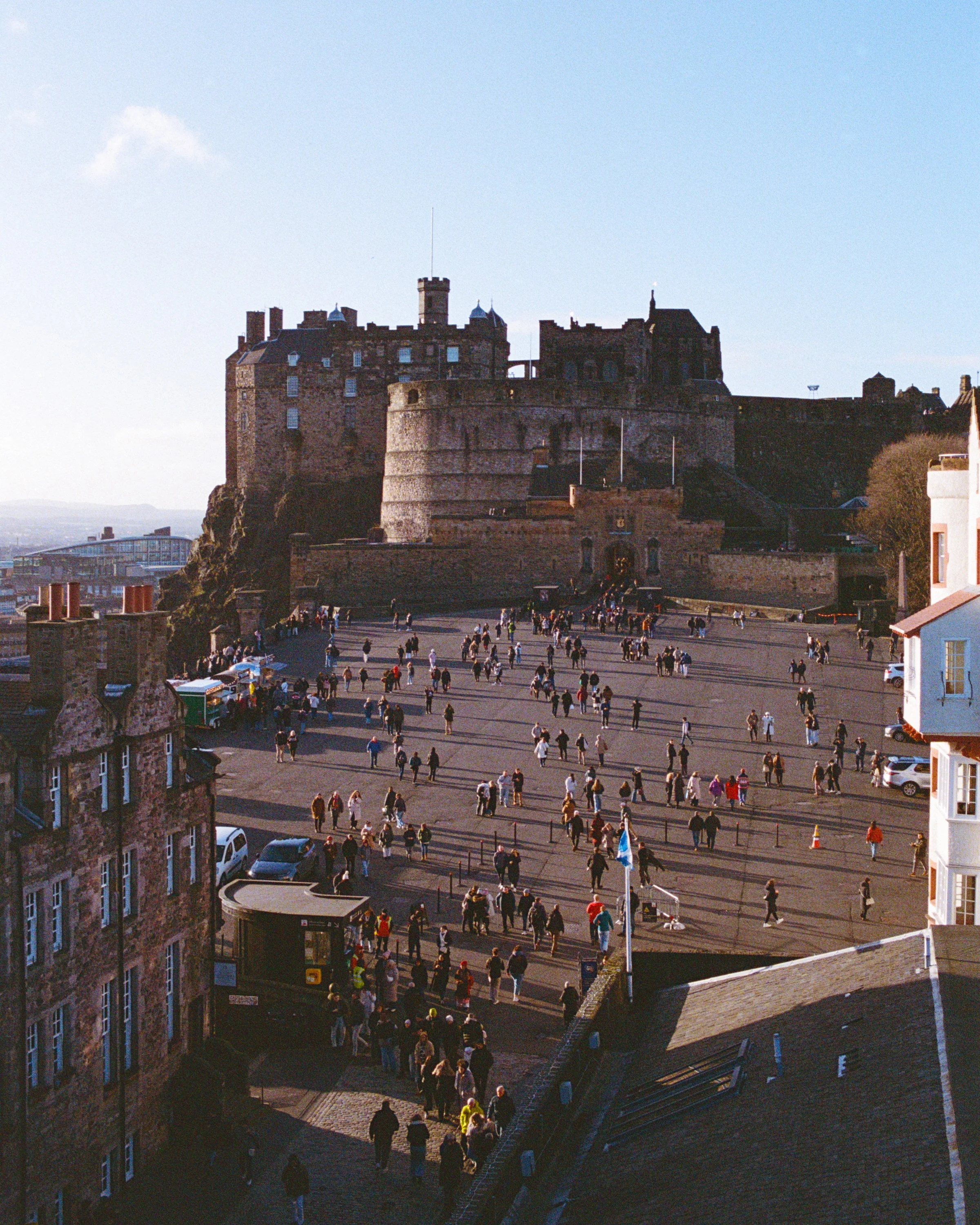 Edinburgh Castle above a crowded esplanade seen from a window