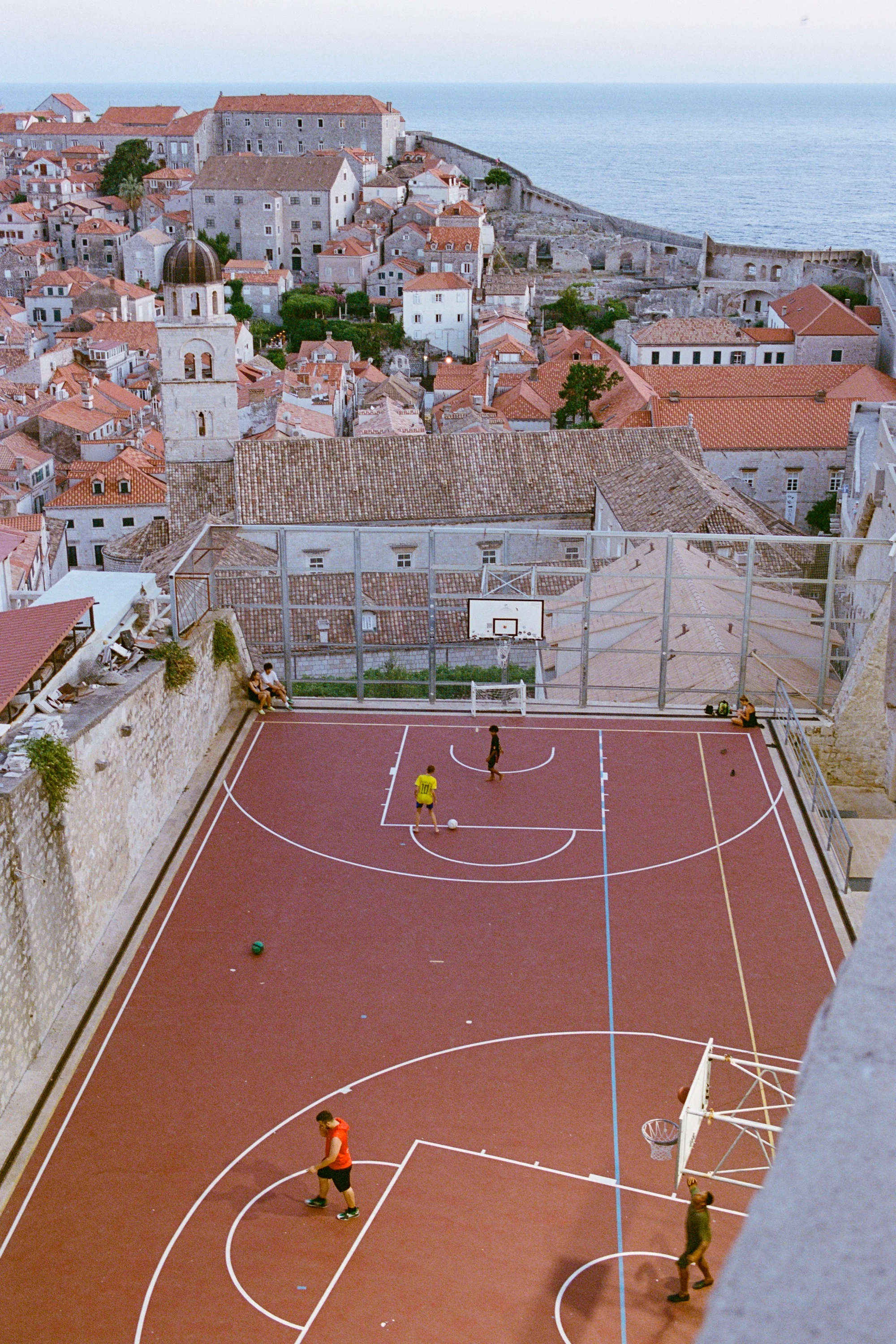 A basketball court inside the old city walls, seen from above