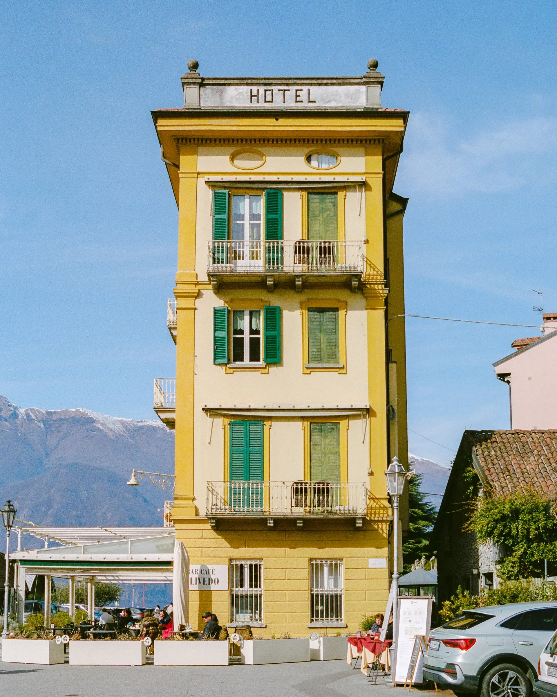 A yellow hotel tower with its name painted down the side