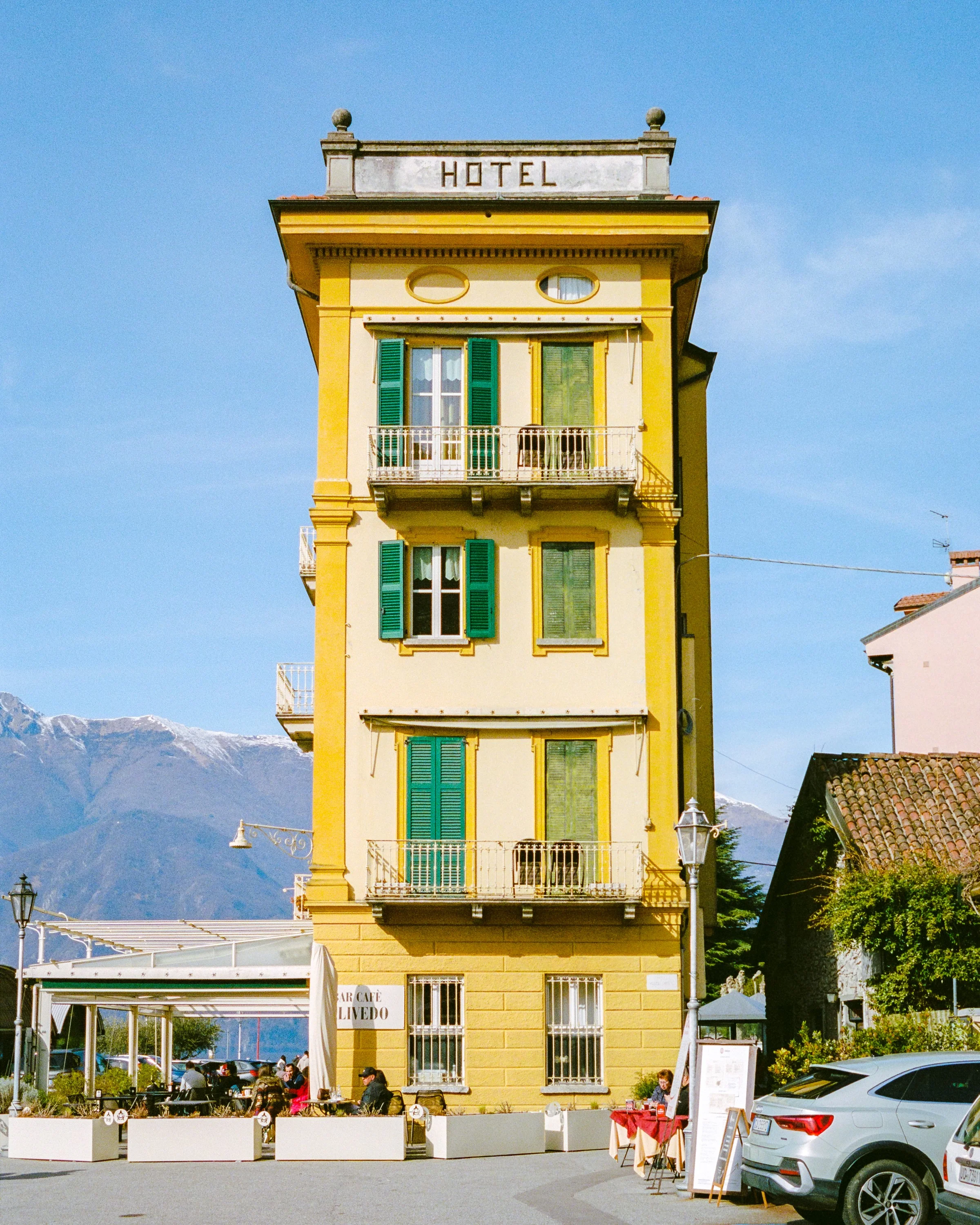 A yellow hotel tower with its name painted down the side
