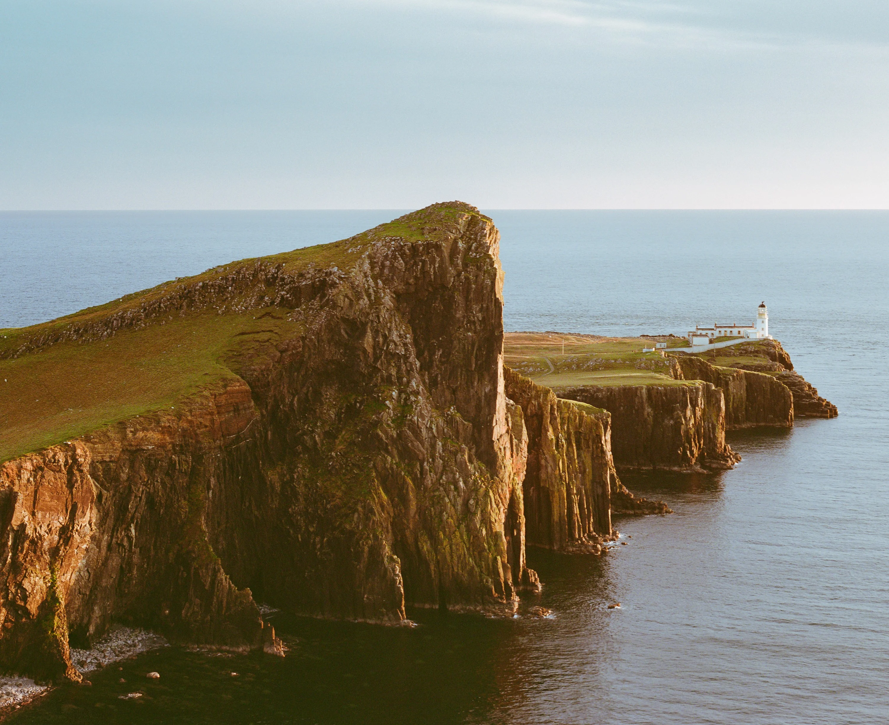 Golden light on the cliffs at Neist Point with the lighthouse at the tip