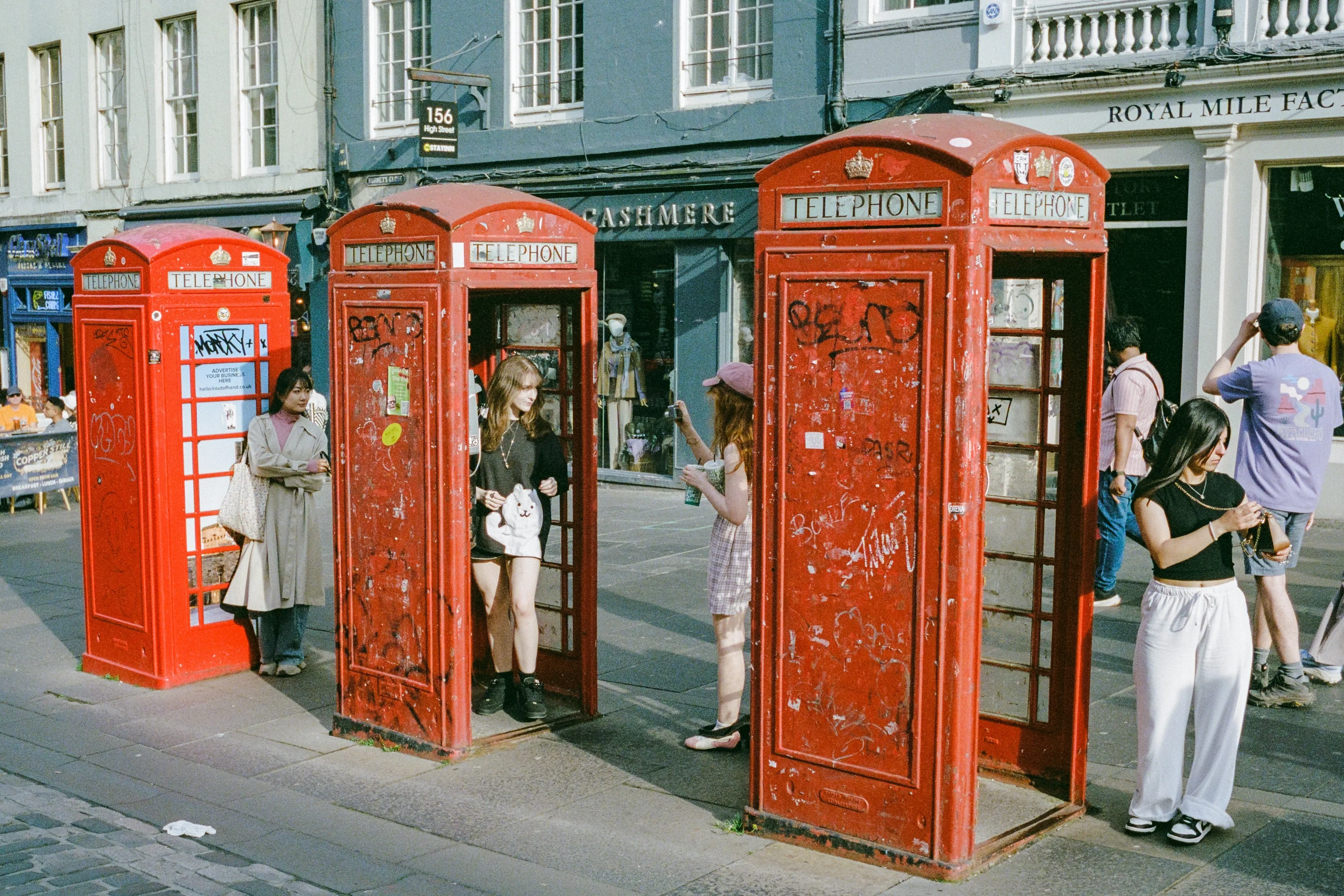 Red phone boxes on a busy street