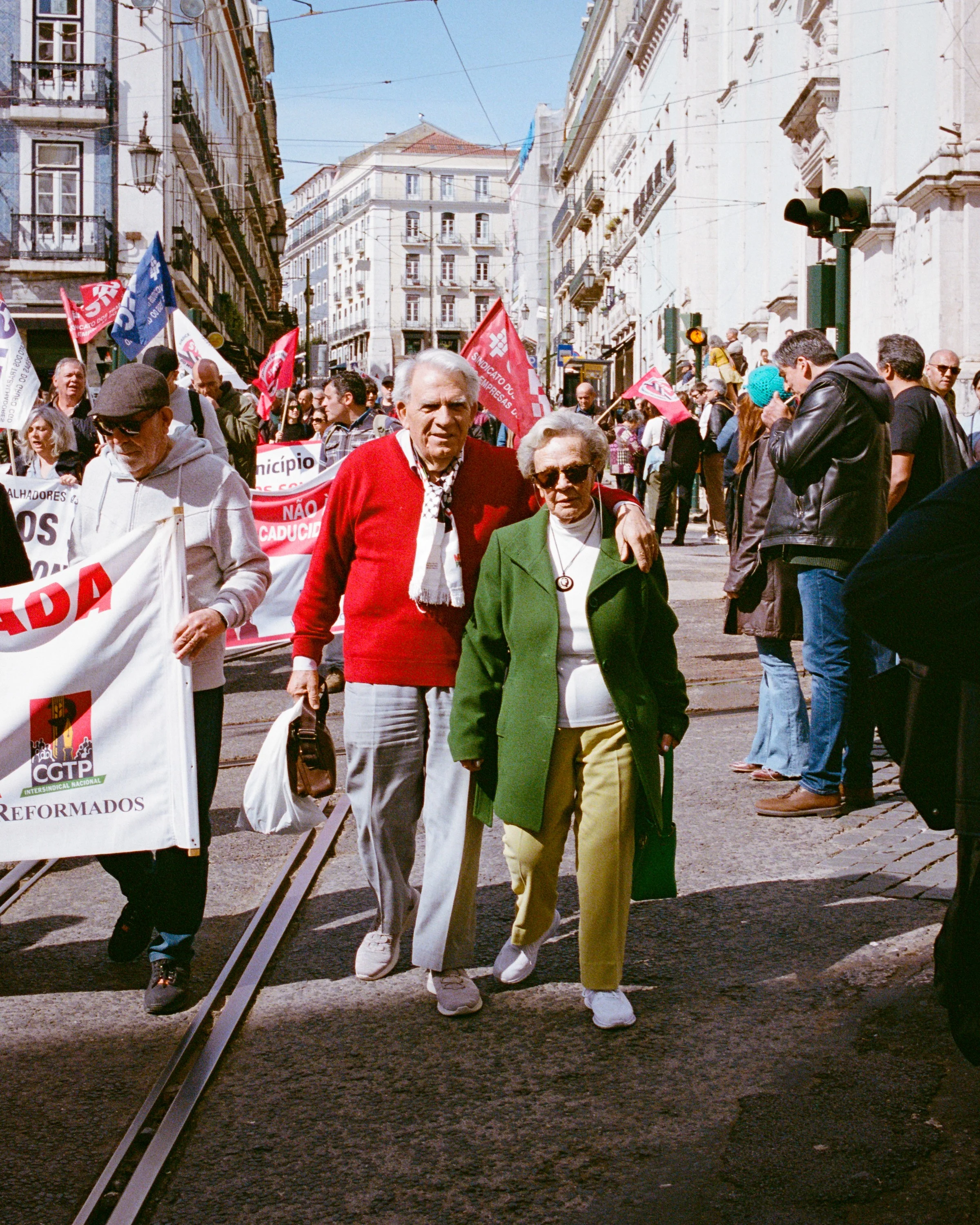 An older couple walking in a march