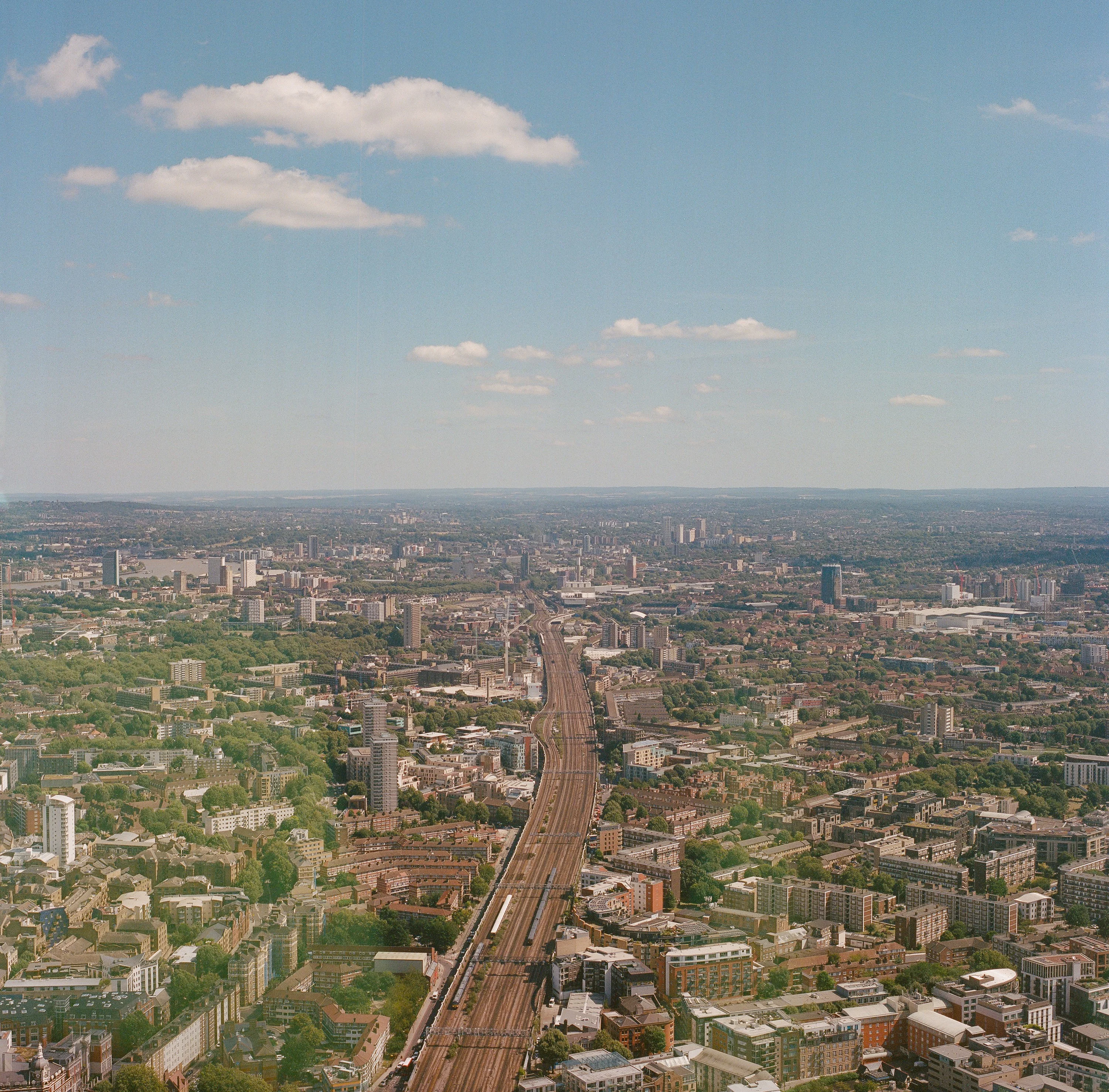 A railway line running through a dense city seen from high above