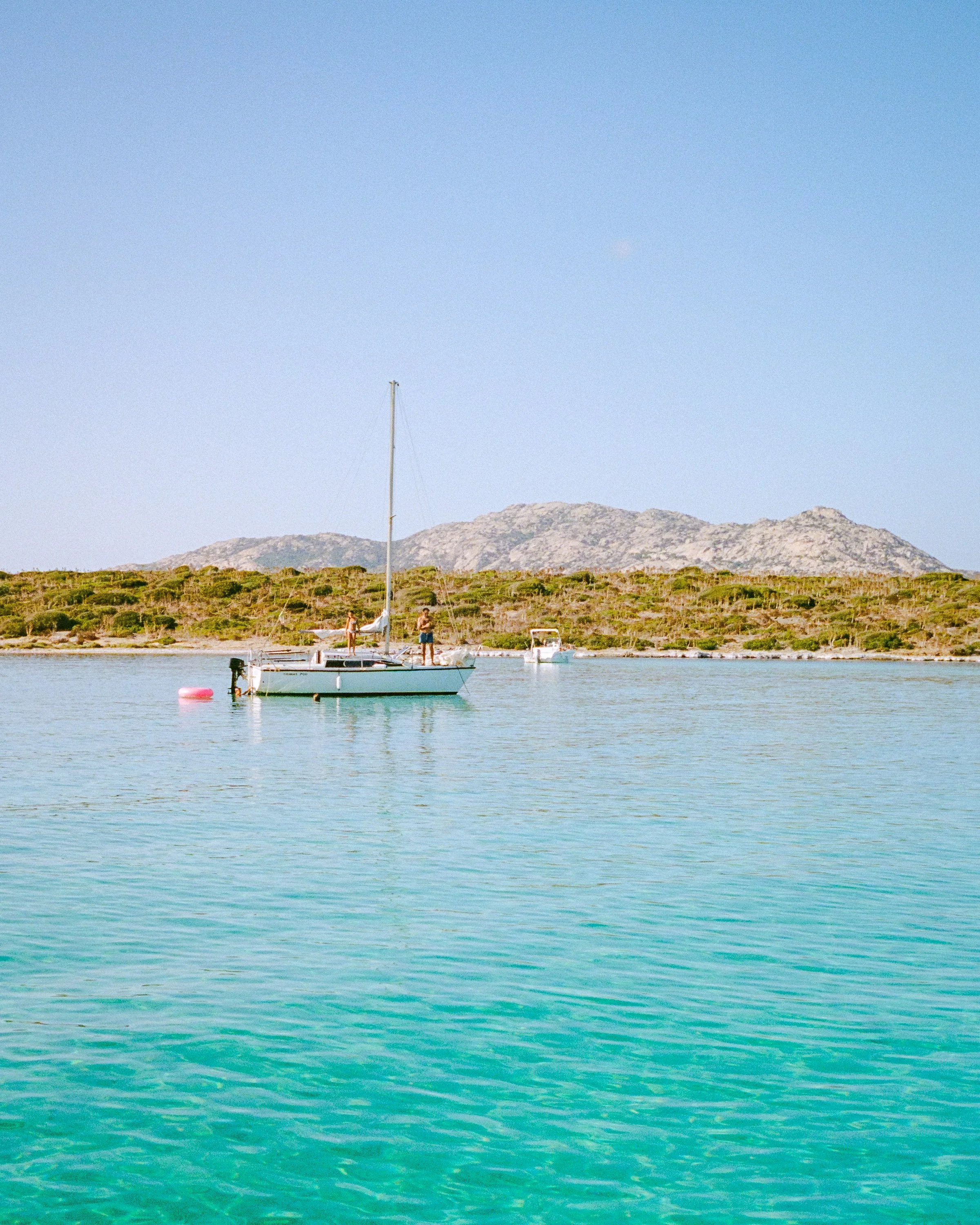 A sailboat on clear turquoise water