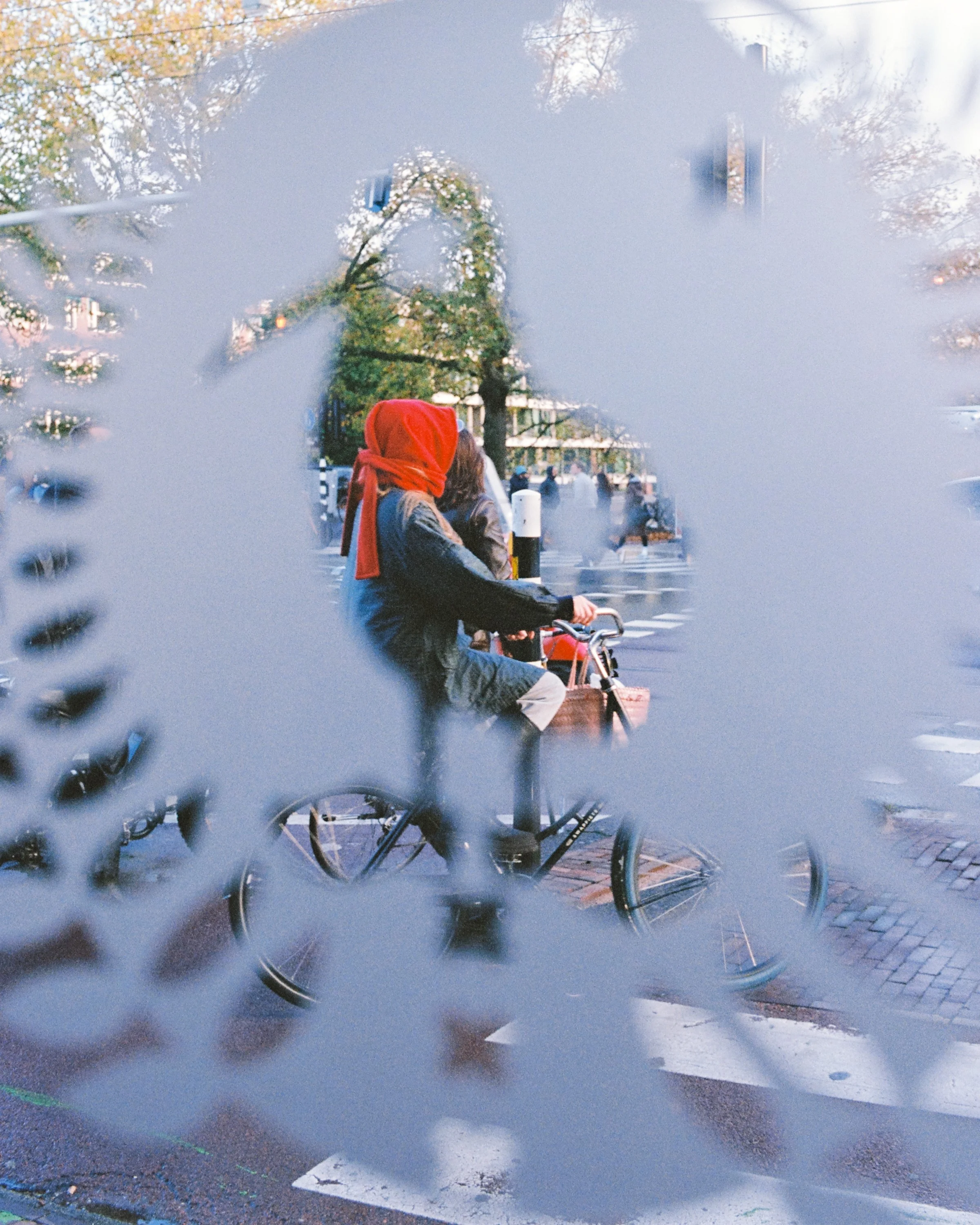 A figure reflected in a pierced metal sculpture