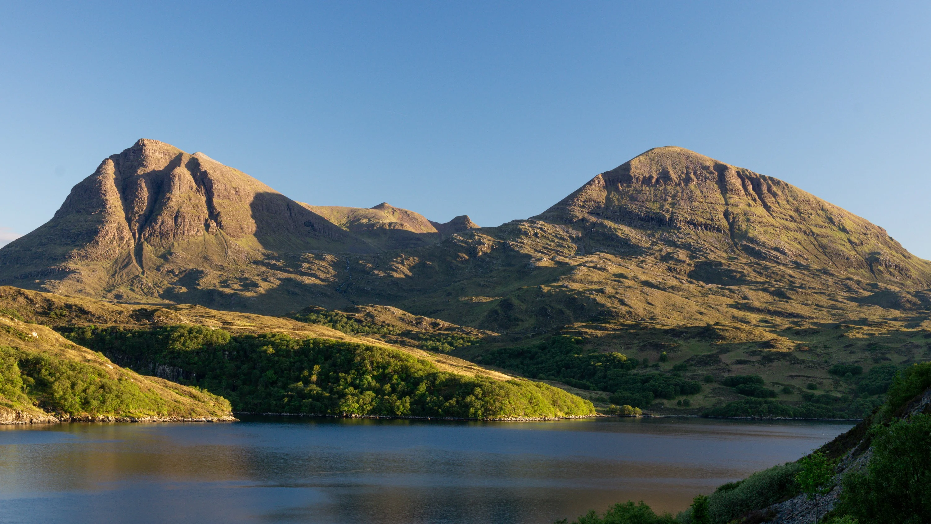 Rugged peaks above a still loch in the Highlands