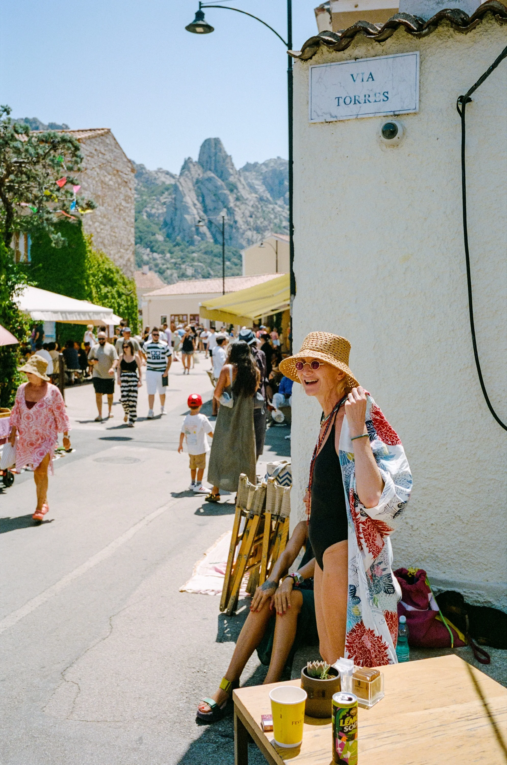 A woman in a sun hat on a busy street