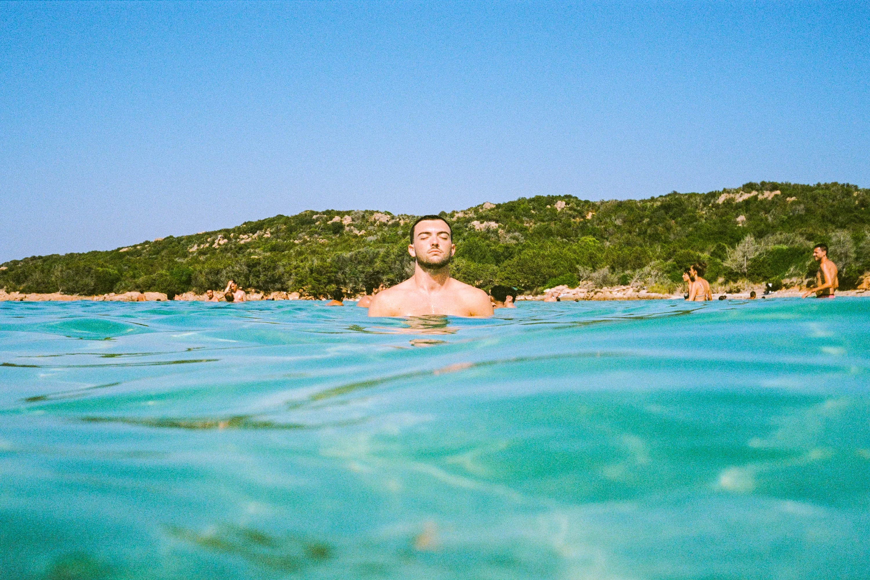 A swimmer floating in turquoise water